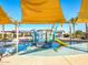 Community pool area featuring shallow splash pool and play structure under shaded awning at 2519 E Fortana Dr, San Tan Valley, AZ 85143