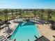 Community pool features a splash pad, lounge seating, ample shade and mature landscaping at 2519 E Fortana Dr, San Tan Valley, AZ 85143