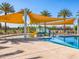 Community pool and pool area featuring a slide, lounge chairs and shaded awnings at 2519 E Fortana Dr, San Tan Valley, AZ 85143