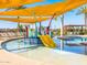 Community pool area featuring slide, lounge chairs, and shaded awning at 2519 E Fortana Dr, San Tan Valley, AZ 85143
