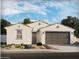 Charming single-story home boasts a neutral palette, low-maintenance landscaping, and an attached two-car garage at 2588 E Grenache Rd, San Tan Valley, AZ 85143