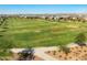 Aerial view of large green athletic field and soccer goal with neighborhood homes and mountains in the background at 2588 E Grenache Rd, San Tan Valley, AZ 85143