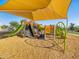 Community playground featuring climbing structures, slides, and sun shades at 2588 E Grenache Rd, San Tan Valley, AZ 85143