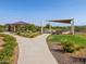 Open community park with shaded picnic spots, well-manicured green spaces, and walking path at 2591 E Fortana Dr, San Tan Valley, AZ 85143