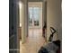Hallway with a tile floor leading to an area with French doors and an adjacent bathroom at 25931 W Deer Valley Rd, Buckeye, AZ 85396