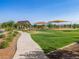 Community park with green lawn and picnic pavilions and playground promote outdoor activities and social gatherings at 2644 E Grenache Rd, San Tan Valley, AZ 85143