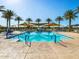 Spacious community pool area features a playful splash pad, comfortable lounge chairs, and shady umbrellas at 2644 E Grenache Rd, San Tan Valley, AZ 85143