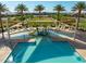Community pool featuring a zero entry play area, sunshades, lounge chairs and palm trees at 2644 E Grenache Rd, San Tan Valley, AZ 85143