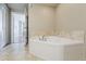 A relaxing, neutral-toned bathroom features an inviting, tile-backed tub and stylish tile flooring at 310 S 4Th St # 1601, Phoenix, AZ 85004