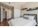 Cozy bedroom featuring hardwood floors, a comfortable bed, closet, and floating decorative shelving at 310 S 4Th St # 1601, Phoenix, AZ 85004