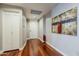 Inviting hallway boasts hardwood floors, neutral paint, and an abstract piece of art at 310 S 4Th St # 1601, Phoenix, AZ 85004