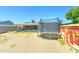Backyard view with trampoline, shed, and solar panels on the house under a clear blue sky at 3107 W Lisbon Ln, Phoenix, AZ 85053