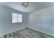 Cozy bedroom features wood-look floors, a window with blinds, and neutral colors, creating a relaxing atmosphere at 3107 W Lisbon Ln, Phoenix, AZ 85053