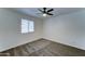 Bedroom with a ceiling fan and a window with blinds, creating a comfortable and inviting retreat at 3107 W Lisbon Ln, Phoenix, AZ 85053