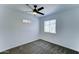 Clean bedroom features neutral carpet, ceiling fan, a window, and a decorative stained glass accent at 3107 W Lisbon Ln, Phoenix, AZ 85053