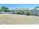 View of a single-story home with a gray exterior, low-maintenance front yard, and covered carport at 3107 W Lisbon Ln, Phoenix, AZ 85053