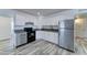 Modern kitchen with stainless steel appliances, white cabinets, and sleek countertops at 3107 W Lisbon Ln, Phoenix, AZ 85053