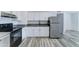 Bright kitchen features white cabinets, stainless steel appliances, and sleek countertops, perfect for cooking enthusiasts at 3107 W Lisbon Ln, Phoenix, AZ 85053