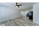 Bright living room featuring sleek wood-look tile flooring and open access to kitchen area at 3107 W Lisbon Ln, Phoenix, AZ 85053