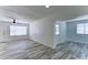 Open-concept living area with wood-look tile floors, and bright white walls at 3107 W Lisbon Ln, Phoenix, AZ 85053