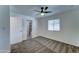 Main bedroom with a ceiling fan and adjacent bathroom, providing a private and comfortable living space at 3107 W Lisbon Ln, Phoenix, AZ 85053