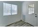 Mud room with a dog door, a window with blinds, and neutral decor, offering functionality and convenience at 3107 W Lisbon Ln, Phoenix, AZ 85053