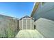 Neutral-colored shed with a white door and window, located in the side yard of a home at 3107 W Lisbon Ln, Phoenix, AZ 85053