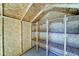Interior view of a wooden shed with exposed rafters and shelving for storage at 3107 W Lisbon Ln, Phoenix, AZ 85053