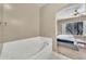Bathroom with a large soaking tub and a view of the bedroom and backyard at 3131 E Legacy Dr # 1032, Phoenix, AZ 85042