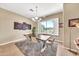 Inviting dining room featuring a modern chandelier, a golf artwork piece, and views of the well-maintained yard at 3131 E Legacy Dr # 1032, Phoenix, AZ 85042