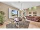 Inviting dining room with a modern chandelier, large window, and view to the living area at 3131 E Legacy Dr # 1032, Phoenix, AZ 85042