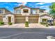 Charming townhome exterior with private garages and well-manicured landscaping under a sunny blue sky at 3131 E Legacy Dr # 1032, Phoenix, AZ 85042