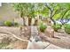 Inviting home exterior featuring a stone staircase, desert landscaping, and mature shade trees at 3131 E Legacy Dr # 1032, Phoenix, AZ 85042