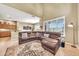 Comfortable living area featuring a large sectional couch, tall ceilings, and bright, natural light at 3131 E Legacy Dr # 1032, Phoenix, AZ 85042