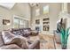 Bright, open living area with a fireplace, high ceilings, and comfortable sectional seating at 3131 E Legacy Dr # 1032, Phoenix, AZ 85042
