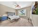 Bright main bedroom with a large window overlooking the backyard, complete with a ceiling fan at 3131 E Legacy Dr # 1032, Phoenix, AZ 85042