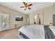 Cozy main bedroom featuring plush carpet, a tufted headboard, access to bathroom and private lanai at 3131 E Legacy Dr # 1032, Phoenix, AZ 85042