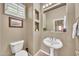 Elegant powder room featuring a pedestal sink, framed art, and built-in shelving at 3131 E Legacy Dr # 1032, Phoenix, AZ 85042