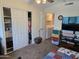Bedroom featuring sliding closet doors, adjacent laundry area, and colorful decor at 3330 E Main St # 121, Mesa, AZ 85213