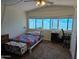 Bright bedroom with natural light, soft carpet, and a quilted bedspread at 3330 E Main St # 121, Mesa, AZ 85213