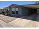 Welcoming single-story home featuring a covered carport and simple rock landscaping at 3330 E Main St # 121, Mesa, AZ 85213