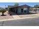 Attractive home showcasing an extended covered patio, carport, and desert-friendly landscaping at 3330 E Main St # 121, Mesa, AZ 85213