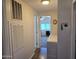 Hallway leading to a brightly lit bedroom and laundry room at 3330 E Main St # 121, Mesa, AZ 85213