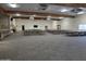 Large community room featuring a stage and rows of neatly arranged tables and chairs at 3330 E Main St # 121, Mesa, AZ 85213