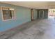 A spacious, covered patio with a view of an access door and side window at 3330 E Main St # 121, Mesa, AZ 85213