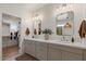Elegant bathroom featuring a double vanity, modern lighting, and a view into the walk-in closet at 3523 E Alfalfa Dr, Gilbert, AZ 85298