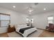 Bright and airy bedroom with hardwood floors, neutral decor, and a ceiling fan for added comfort at 3523 E Alfalfa Dr, Gilbert, AZ 85298
