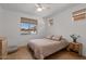 Cozy bedroom featuring a ceiling fan, neutral tones, and a large window for natural light at 3523 E Alfalfa Dr, Gilbert, AZ 85298
