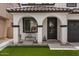Inviting covered front porch with arched supports, decorative seating, and low-maintenance landscaping at 3523 E Alfalfa Dr, Gilbert, AZ 85298