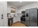 Modern kitchen with stainless steel appliances, white cabinets, and a stylish faucet at 3523 E Alfalfa Dr, Gilbert, AZ 85298